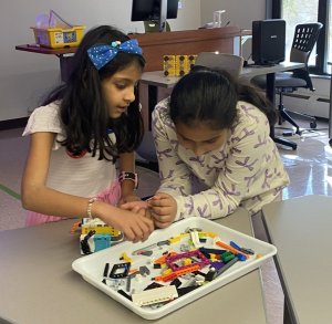 Two girls work on creating a robot at 4-H Family STEM Day.